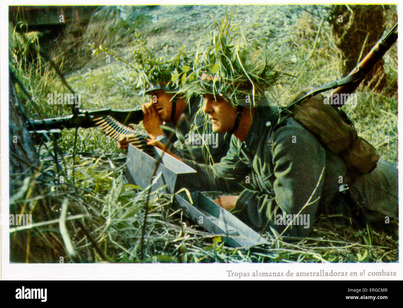 German soldiers in combat. Caption reads: 'German machine-gunners in combat' ('Tropas alemanas de ametralladoras en el Stock Photo