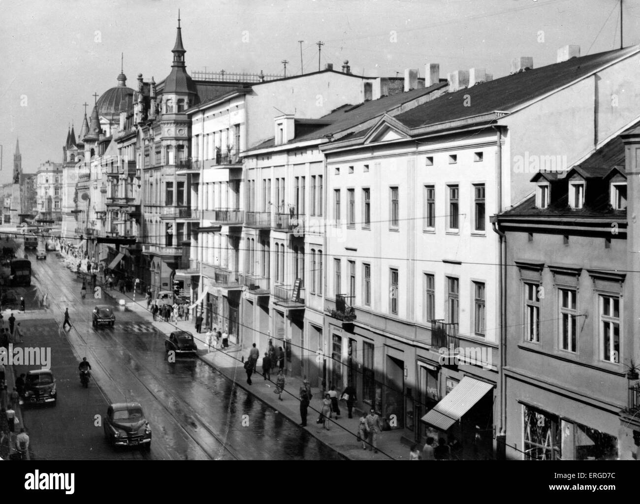 Part of Piotrkowskiej Street, Łódź, Poland. Shows cars, passersby and various buildings. 1930s (?) Stock Photo