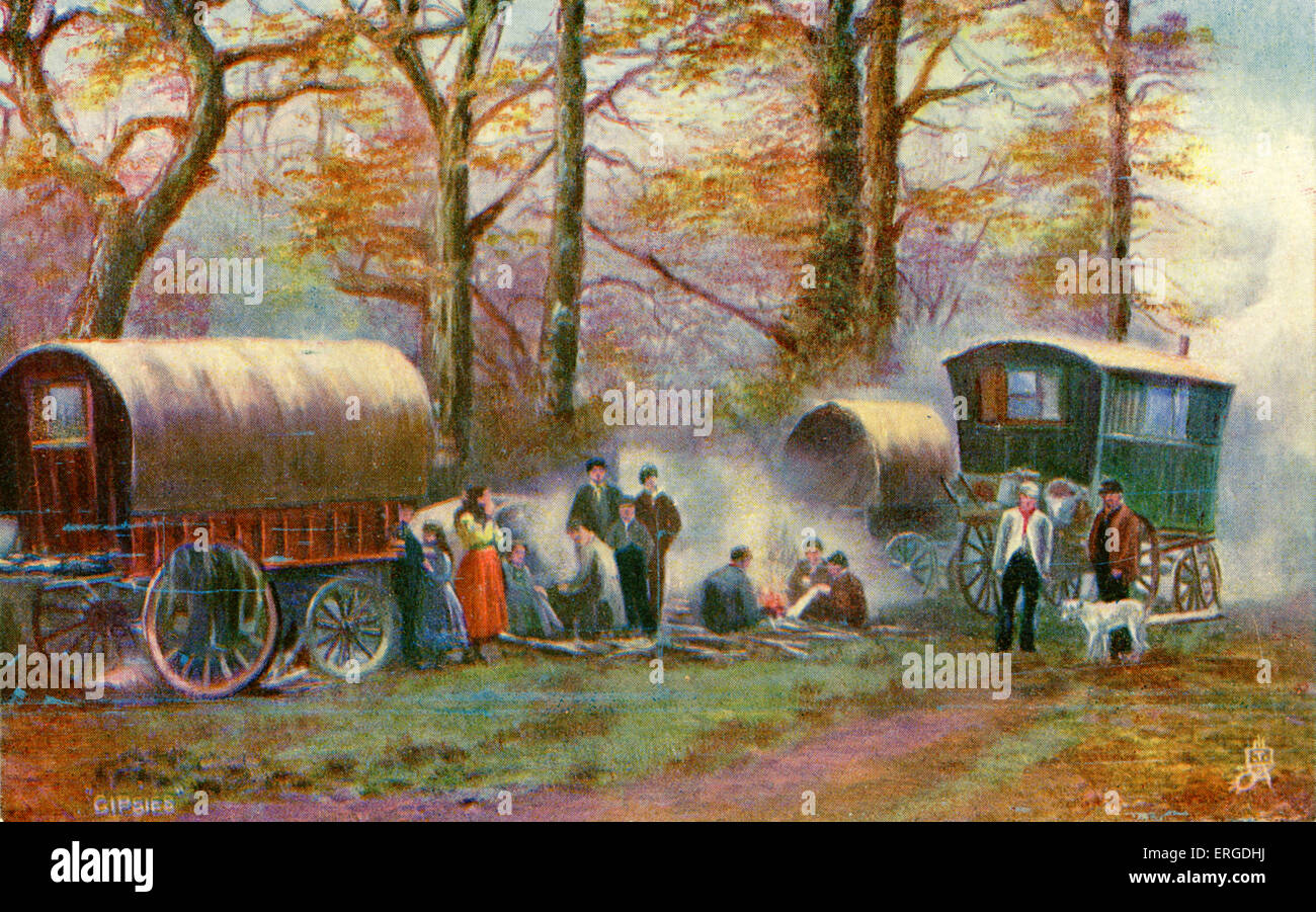 Gypsy camp in the countryside. Shows gypsies gathered round a fire, with caravans. Stock Photo