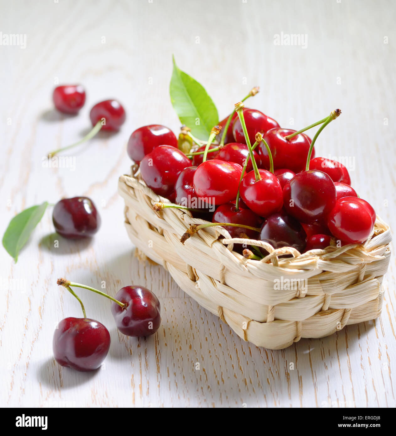 ripe cherries in small basket Stock Photo