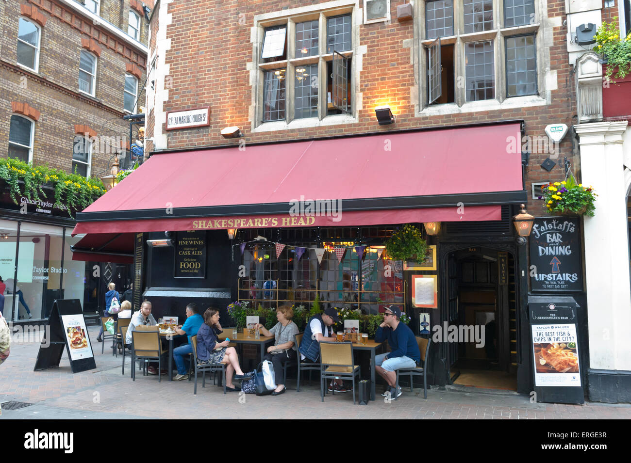 A group of people sitting and drinking outside the Shakespeare ...