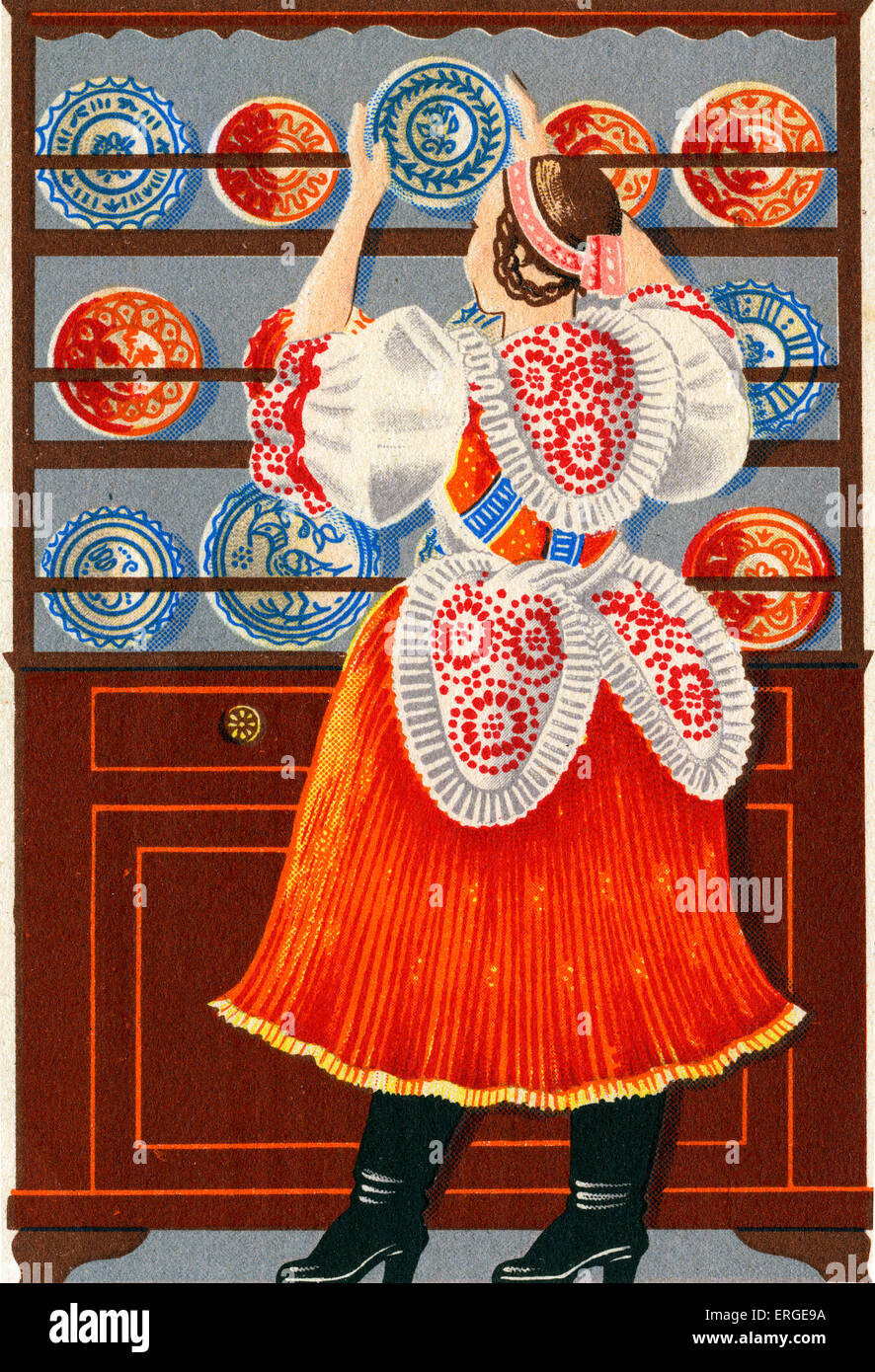 Woman in traditional Hungarian dress - placing a decorated plate in a dresser. 1950s. Radio Budapest postcard. Stock Photo