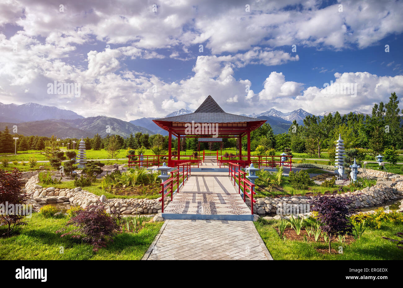 Japanese garden with red pagoda at mountains and blue sky in dendra park of first president in Almaty, Kazakhstan Stock Photo