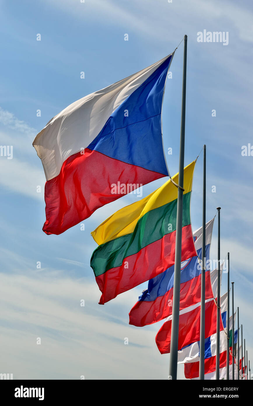 Flags of different countries of European Union waving on blue sky. Czech Republic flag is on foreground Stock Photo
