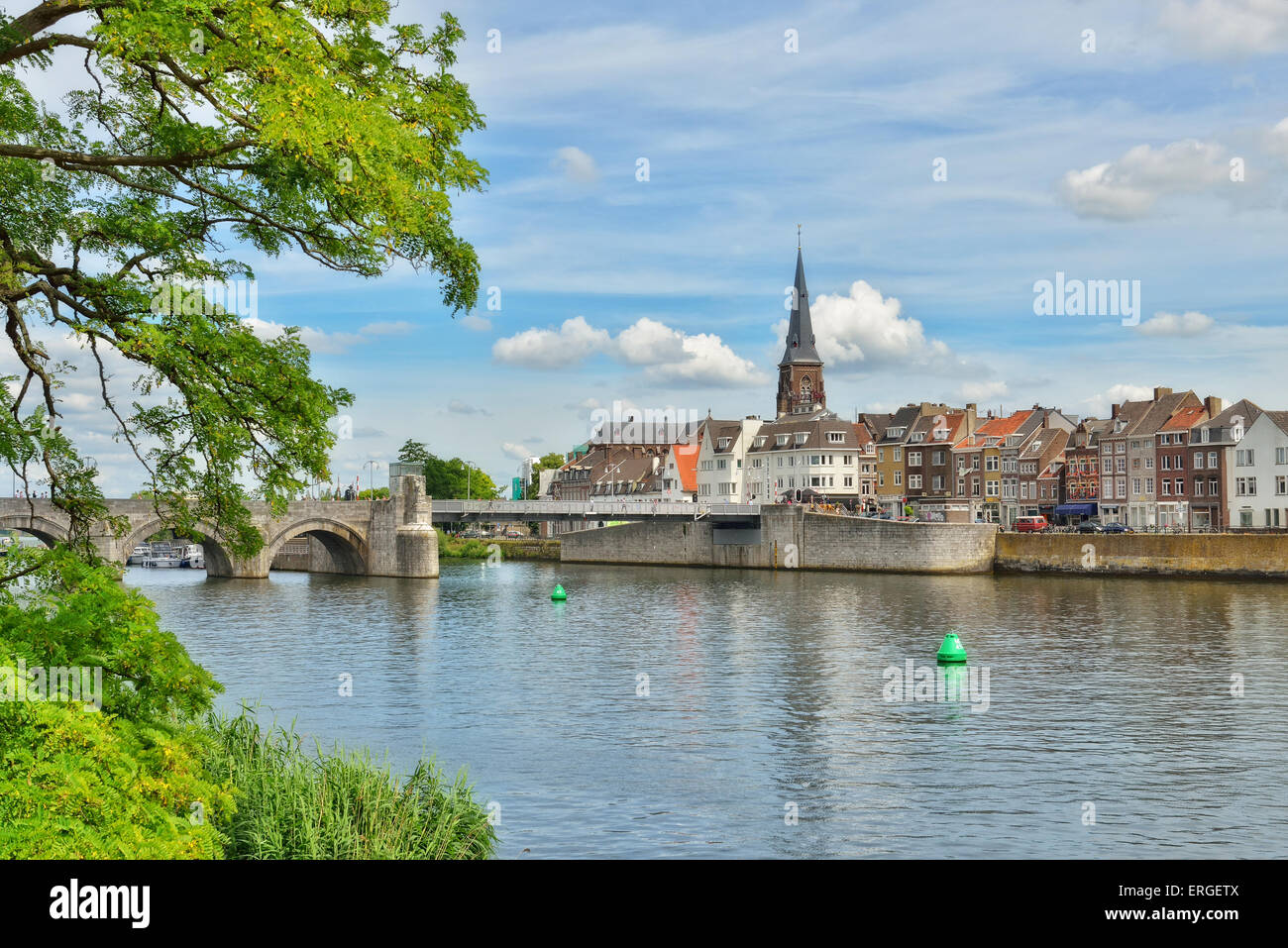 Maastricht view from river Maas or Meuse in calm summer day with small white clouds Stock Photo