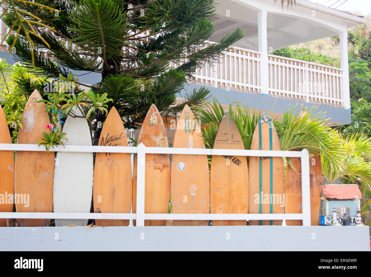 Surfboards line the fence of a home in the Corossol neighborhood of St. Barts Stock Photo