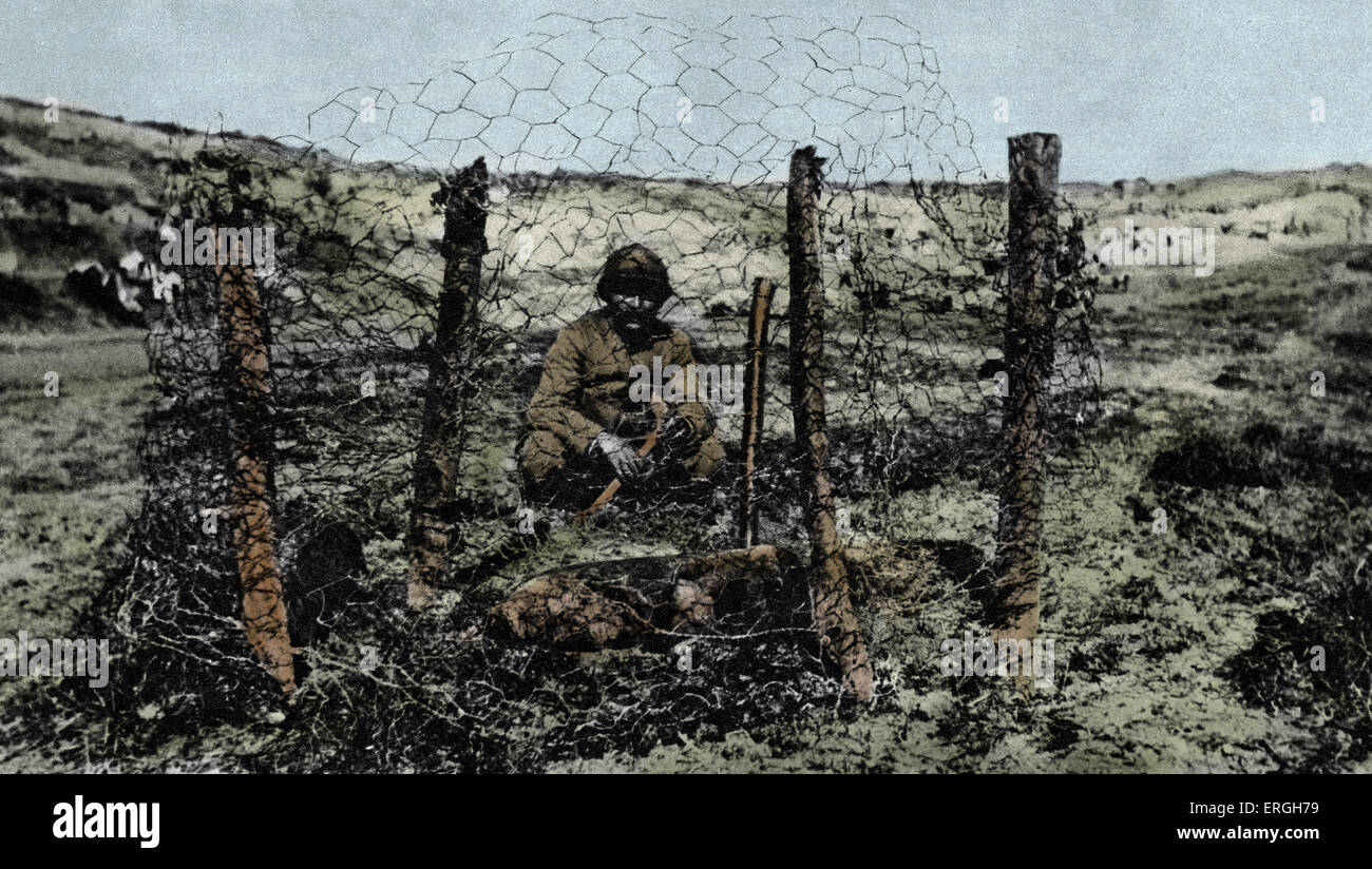 Unexploded German shell at Verdun during World War 1.  French solider encases the area in wire netthing to prevent injury. Stock Photo