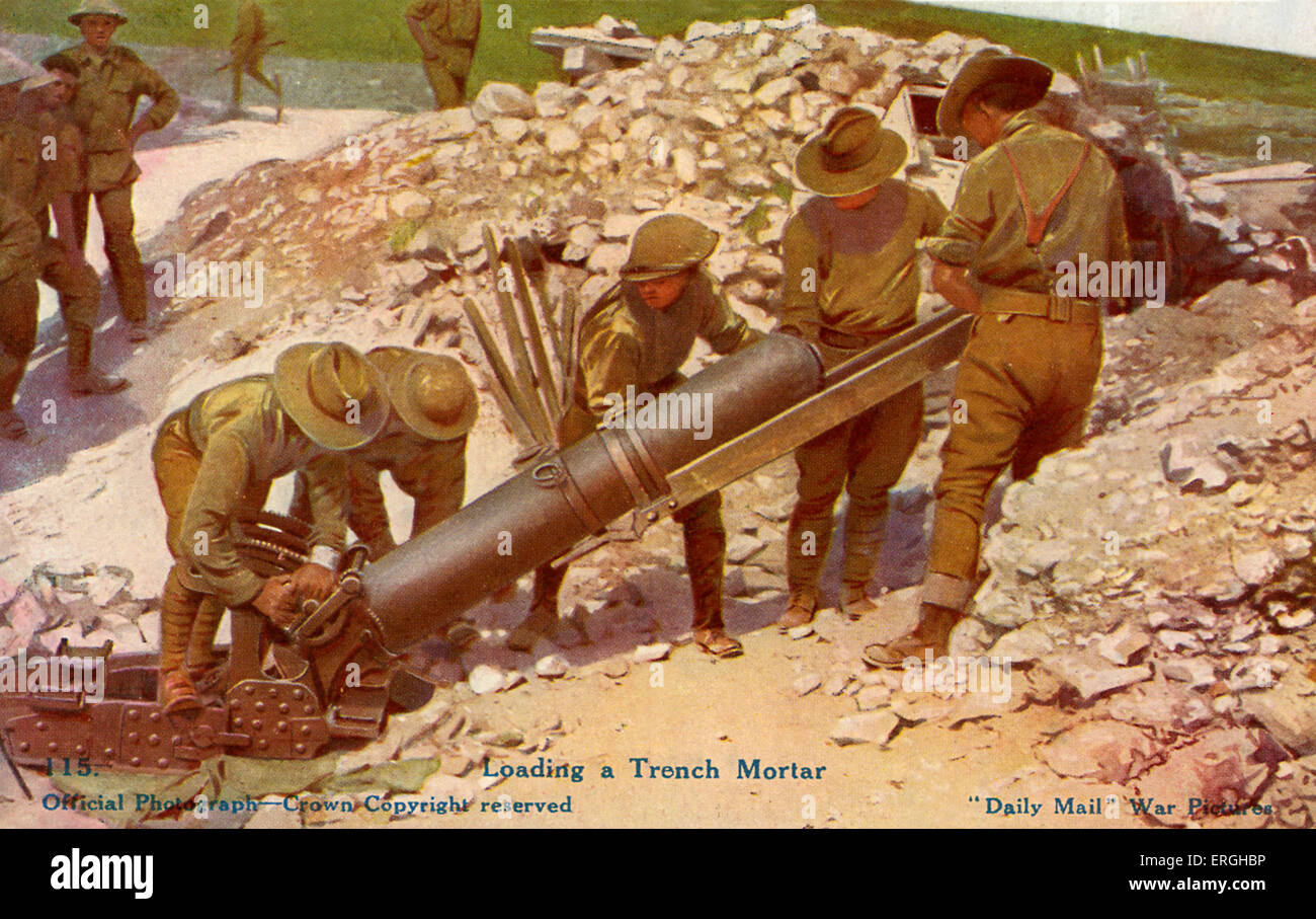 World War 1: British soldiers loading a trench mortar (indirect fire weapon that fires explosive projectiles). British Official Stock Photo