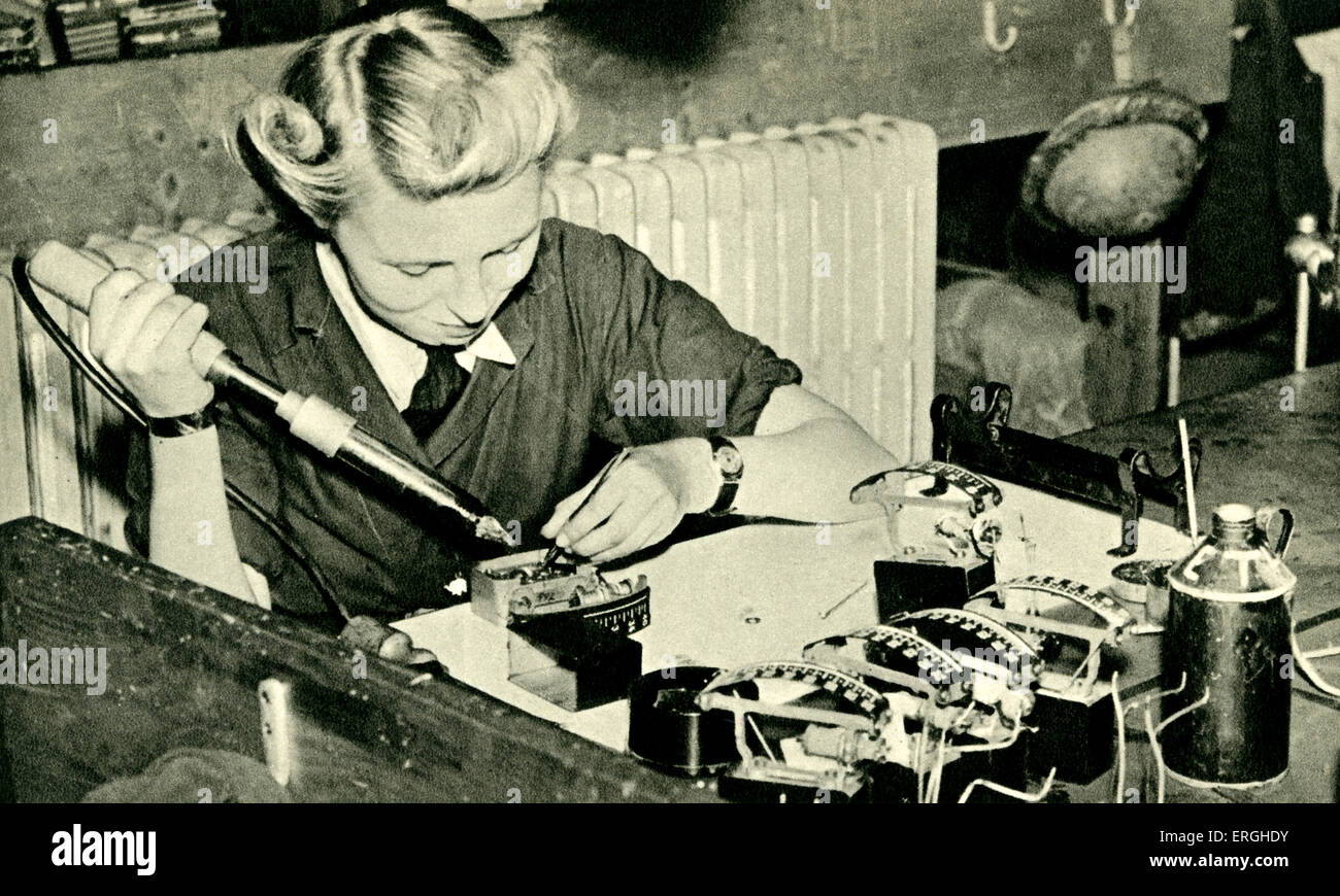 World War 2: British  Women's Auxiliary Air Force. Woman repairing electical engine speed indicators. Female auxiliary division Stock Photo