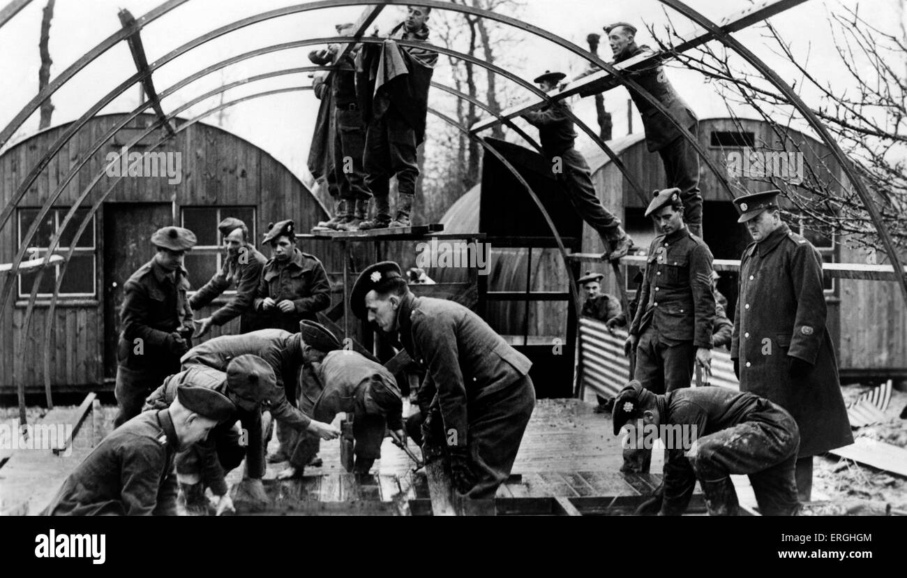 World War 2: Auxiliary Military Pioneer Corps in France. Caption: 'Preparing for the arrival of the new army. Many of these men fought in the last war. Many have sons in the army, but they are still determined to help. These men are constructing army huts'. British Army combatant corps used for light engineering tasks. Raised on 17 October 1939, renamed the Pioneer Corps on 22 November 1940. Postcard issued by Ministry of Information. War Office Photograph No.B.1490. Stock Photo