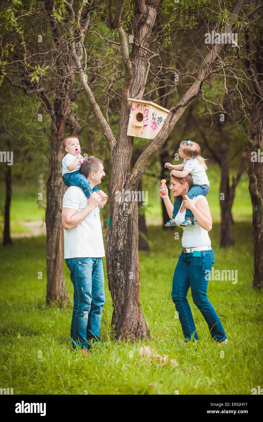 Happy family with Wooden birdhouse Stock Photo