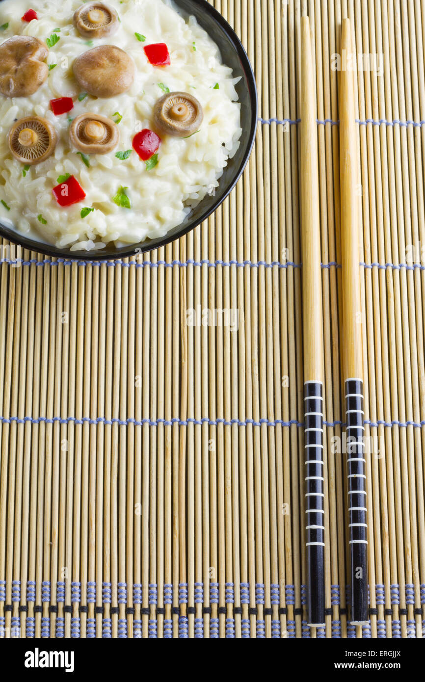 Saffron Milk Cap mushroom rice with white wine sauce on a bamboo mat