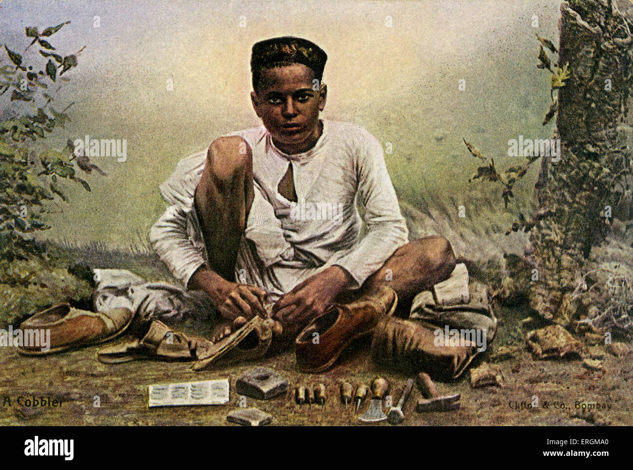 An Indian cobbler. Colorized photograph from early 20th century. Around him are the tools of his trade, including hammers, Stock Photo