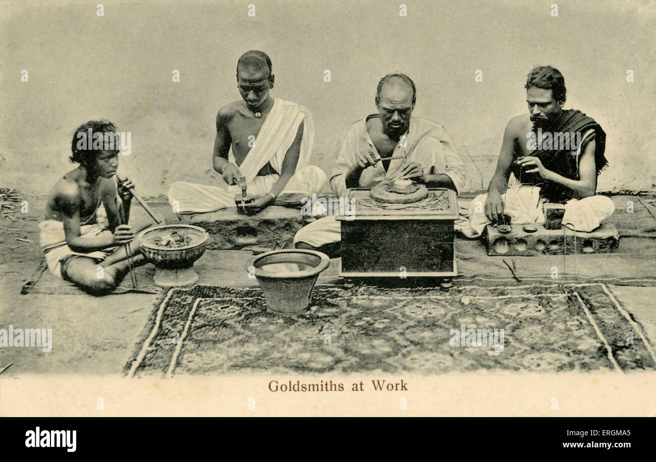 Indian goldsmiths at work. Photograph from early 20th century. On the left a child heats cinders, in the middle, two men work Stock Photo
