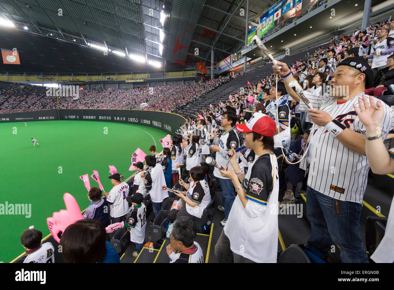 An elderly Japanese man watches a game of his home baseball team- the  Hokkaido Nippon Ham Fighters, at the Sapporo Dome Stock Photo - Alamy