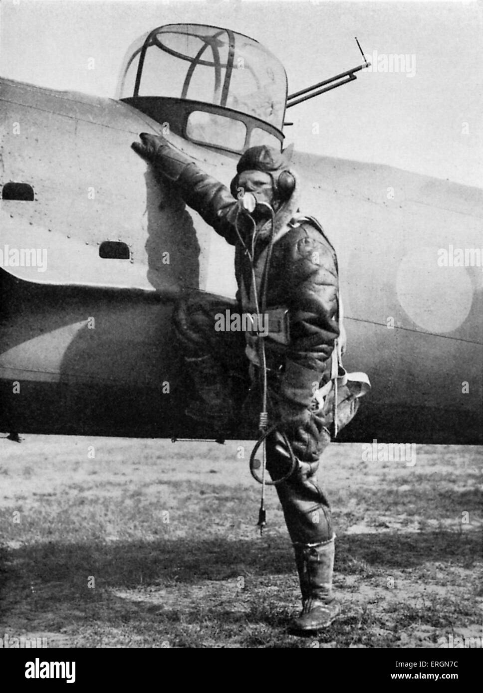 WW2 - Equipment of a British pilot. RAF pilot in full gear next to his plane. Caption reads: Equipped for air fighting: oxygen, Stock Photo