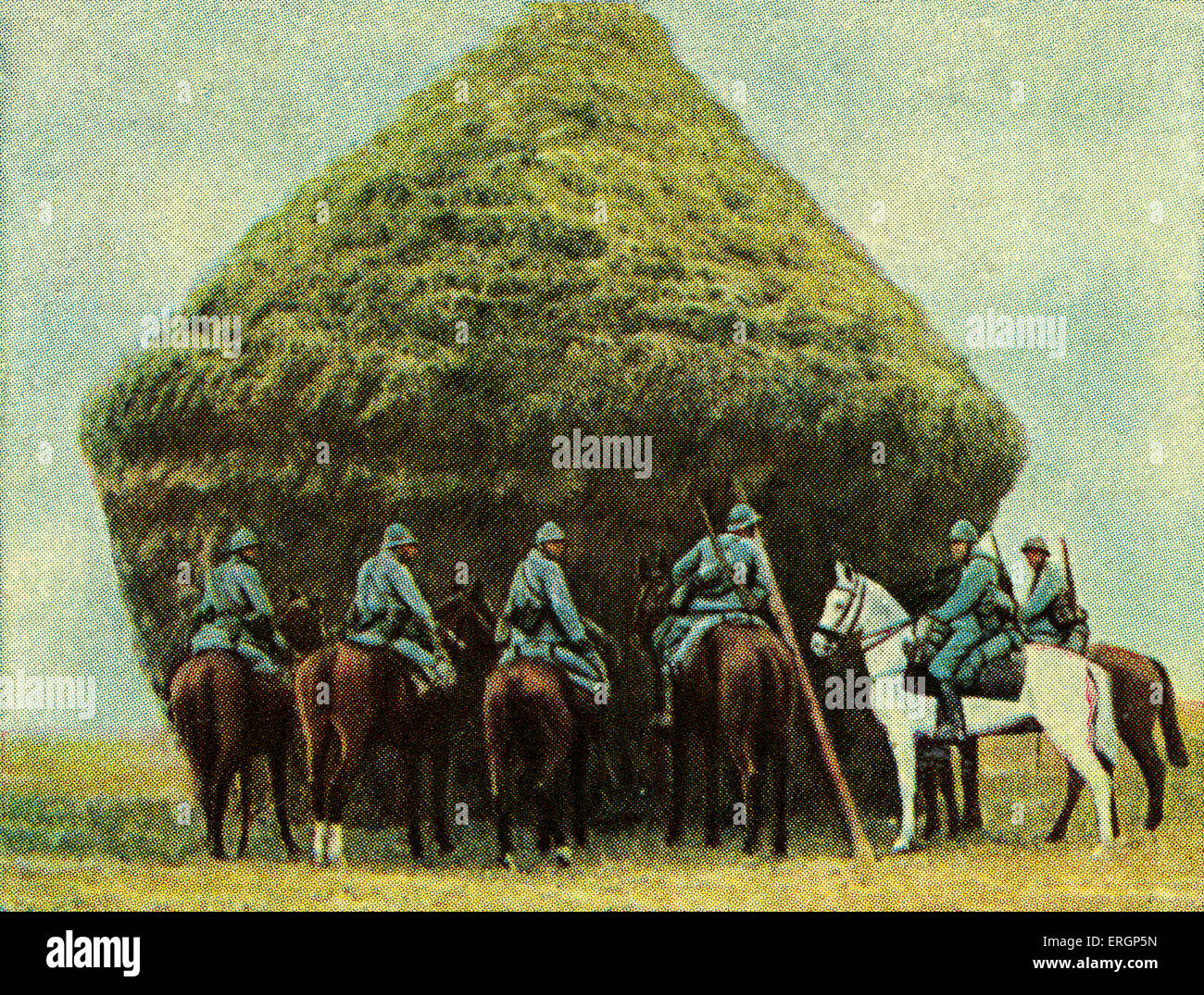 French cavalry hding behind haystack - camouflage.   (Source: Cigarette cards published in Germany c.1934 reviewing military Stock Photo