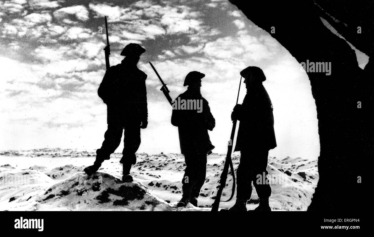 WWII - Silhouettes of three soldiers with bayonets in the snow, Western Front. Caption reads: ' The Watch goes on: Sunset on the Western Front, but still Britain stands guard.' Official War Office photograph. Stock Photo