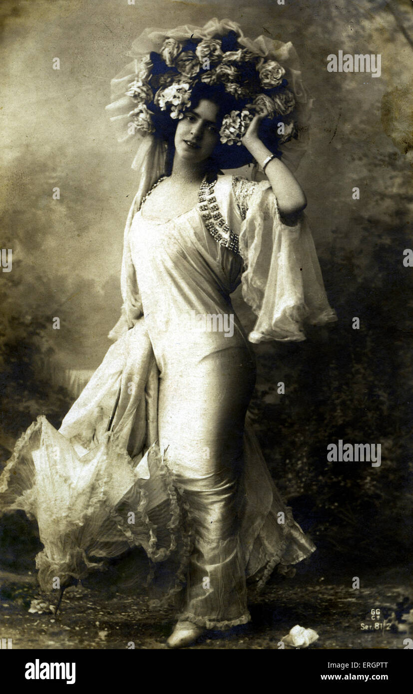 Glamourous dress, early 20th century. Woman in a satin dress, with a jewelled shrug jacket with long flowing sleeves, Stock Photo