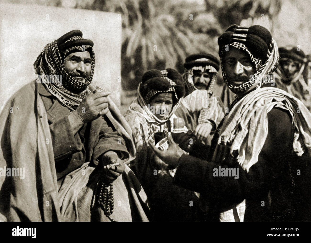 A Sheikh enjoying the famous Arab Coffee in Iraq - Photo taken in 1920s after creation of Iraq ( from Baghdad, Camera Studio Stock Photo