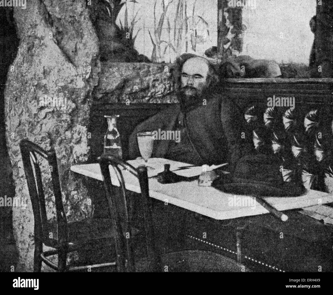 Paul Verlaine  - portrait in front of a glass of absinthe at the Café Procope, Paris, France.French poet, 1844 - 1896. Stock Photo