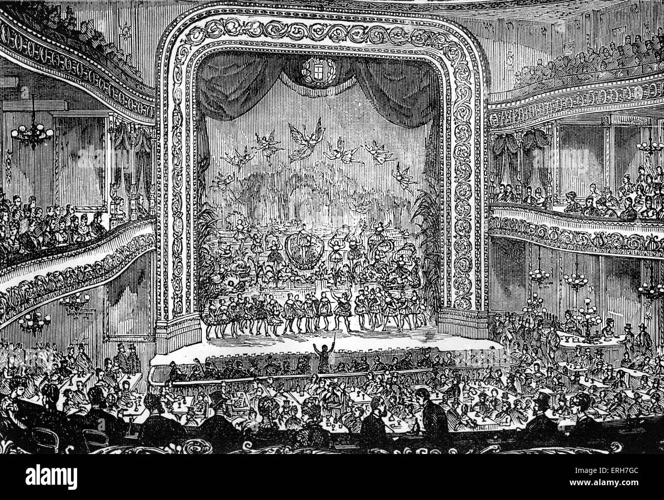 19th century theatre interior, showing the stage, seating, audience and performers. Musical with conductor waving baton for Stock Photo