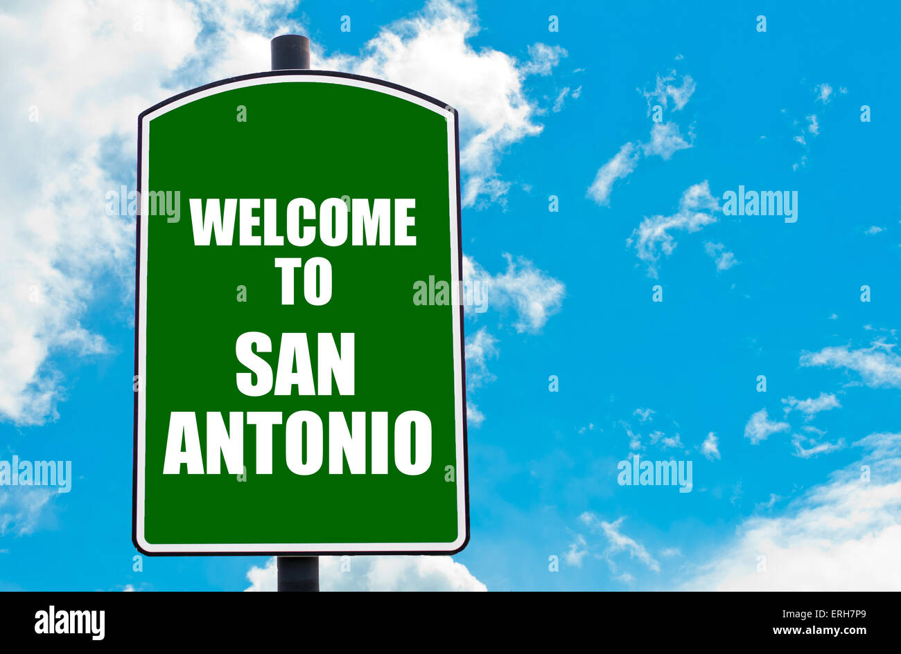 Green road sign with greeting message Welcome to SAN ANTONIO isolated over clear blue sky background with available copy space. Travel destination concept image Stock Photo