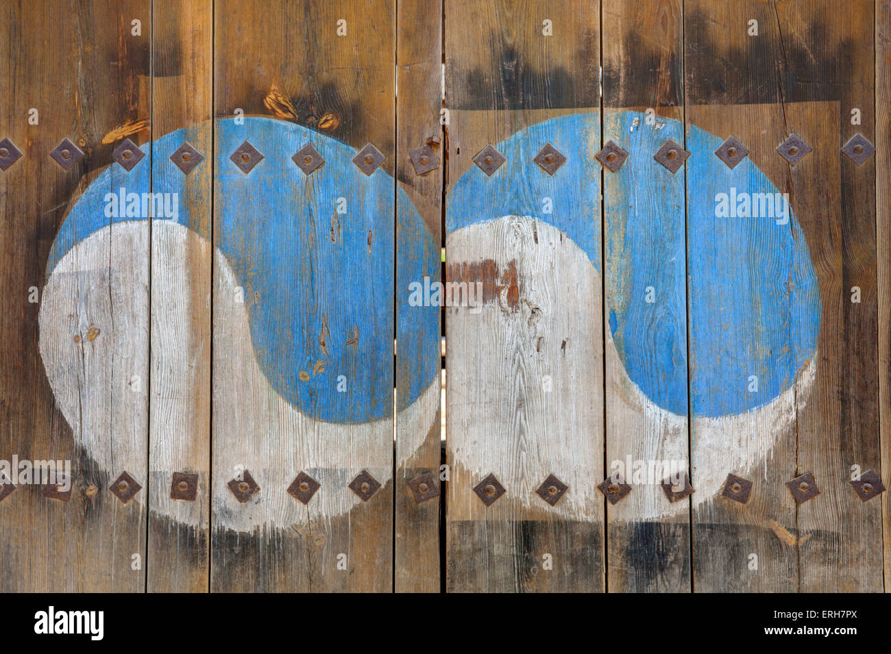The Ying Yang sign painted on wooden door. Stock Photo