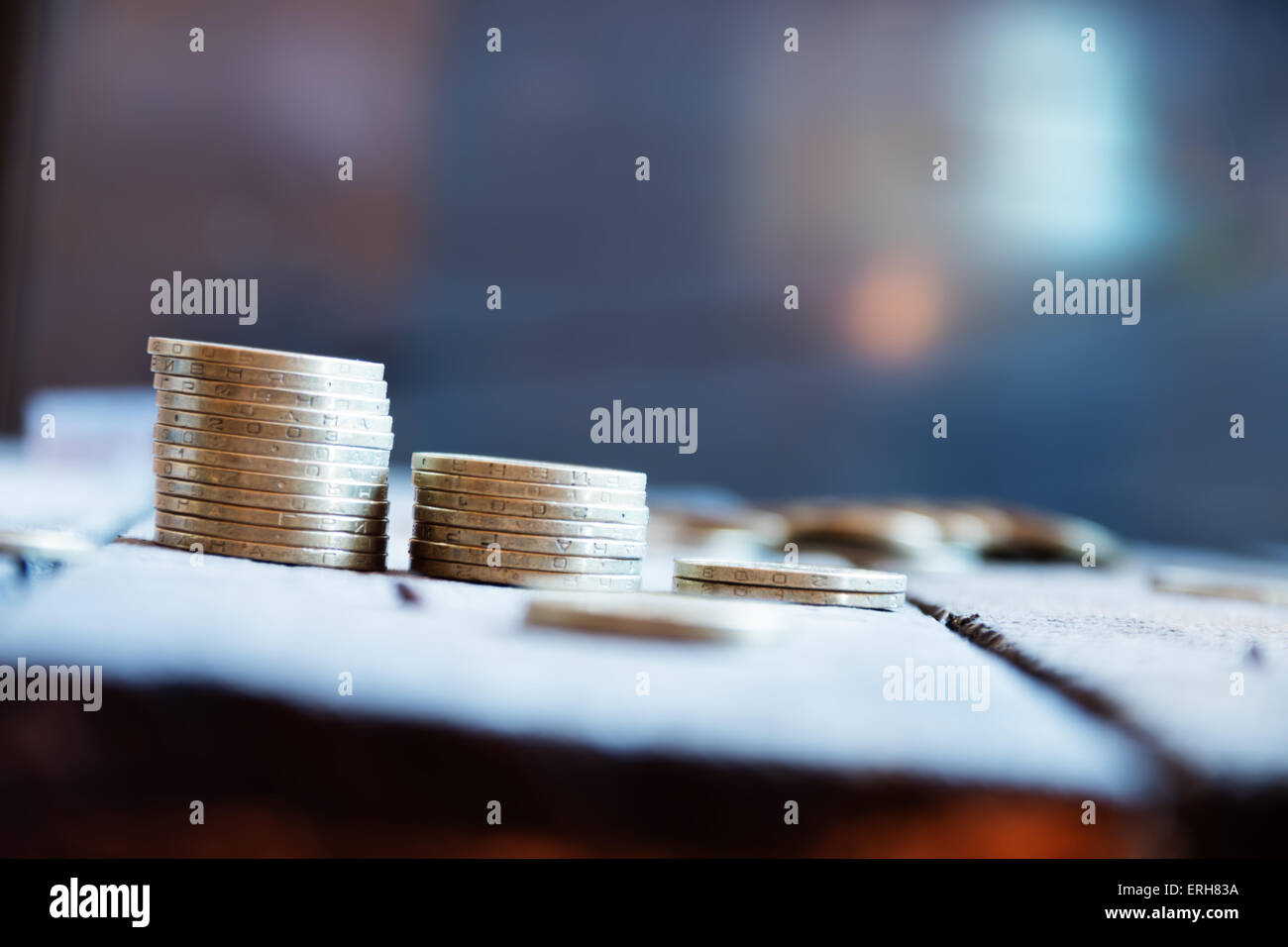 coin stack on a blue background, soft focus Stock Photo - Alamy