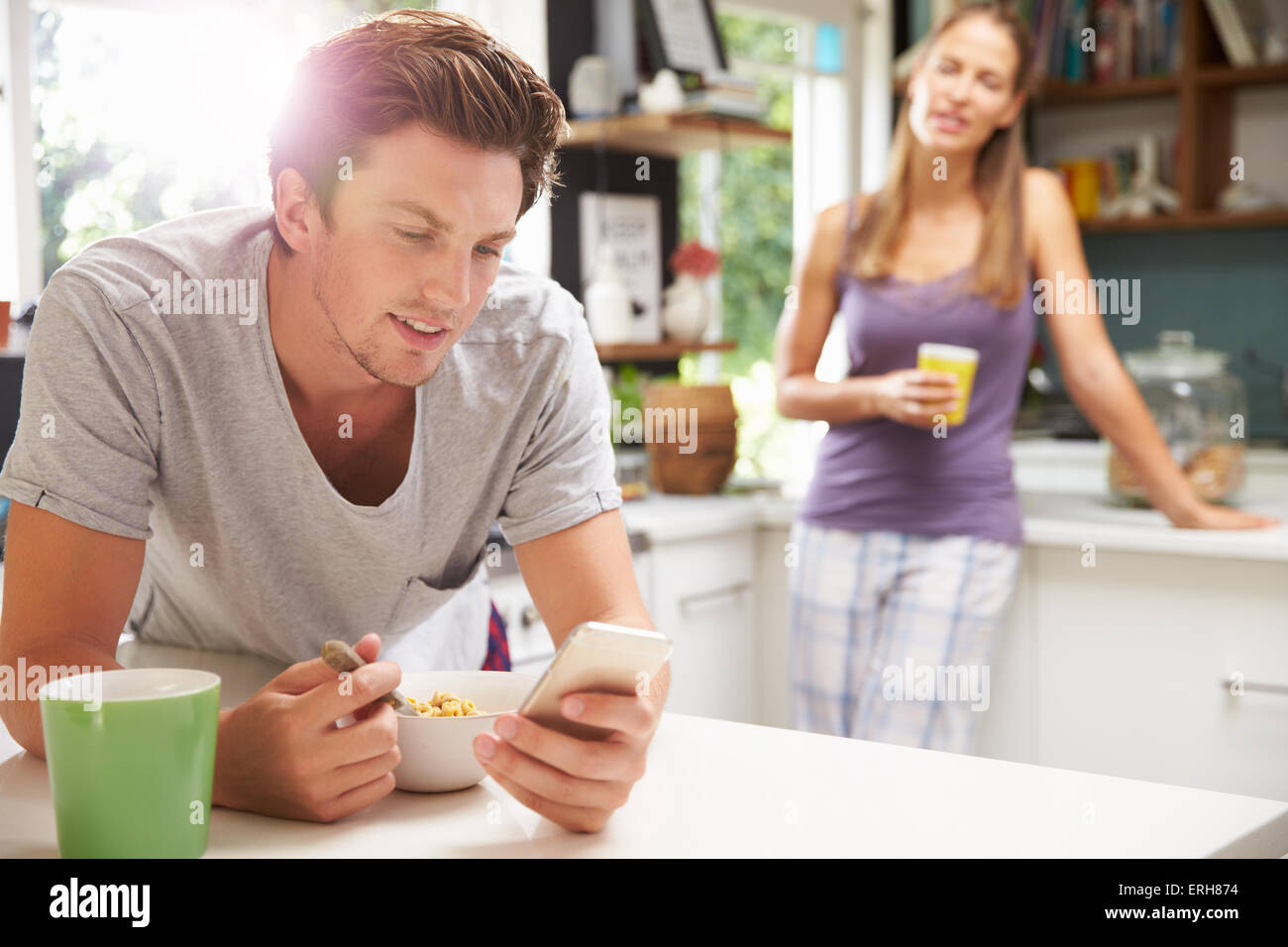 Woman eating breakfast texting on hi-res stock photography and images ...