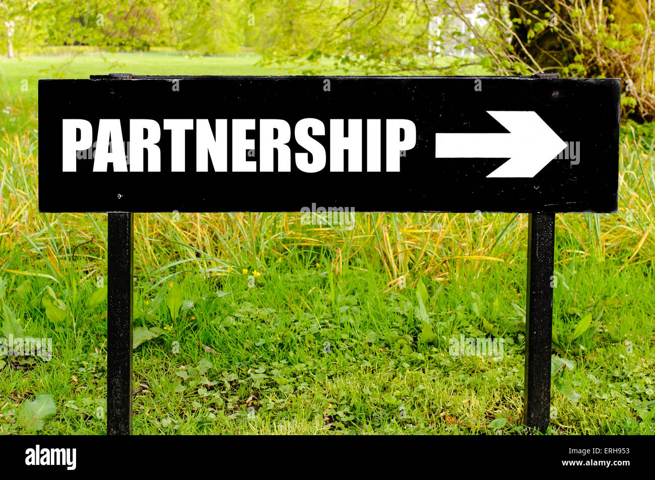 Partnership Project Sign PARTNERSHIP written on directional black metal sign with arrow pointing ...