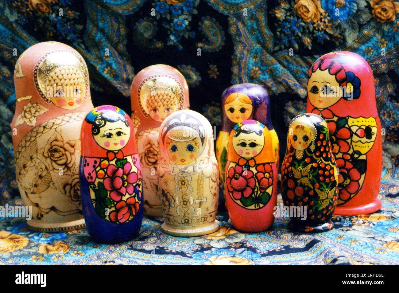 RUSSIA -Handicrafts -Wooden dolls with traditional woven scarf in background Stock Photo