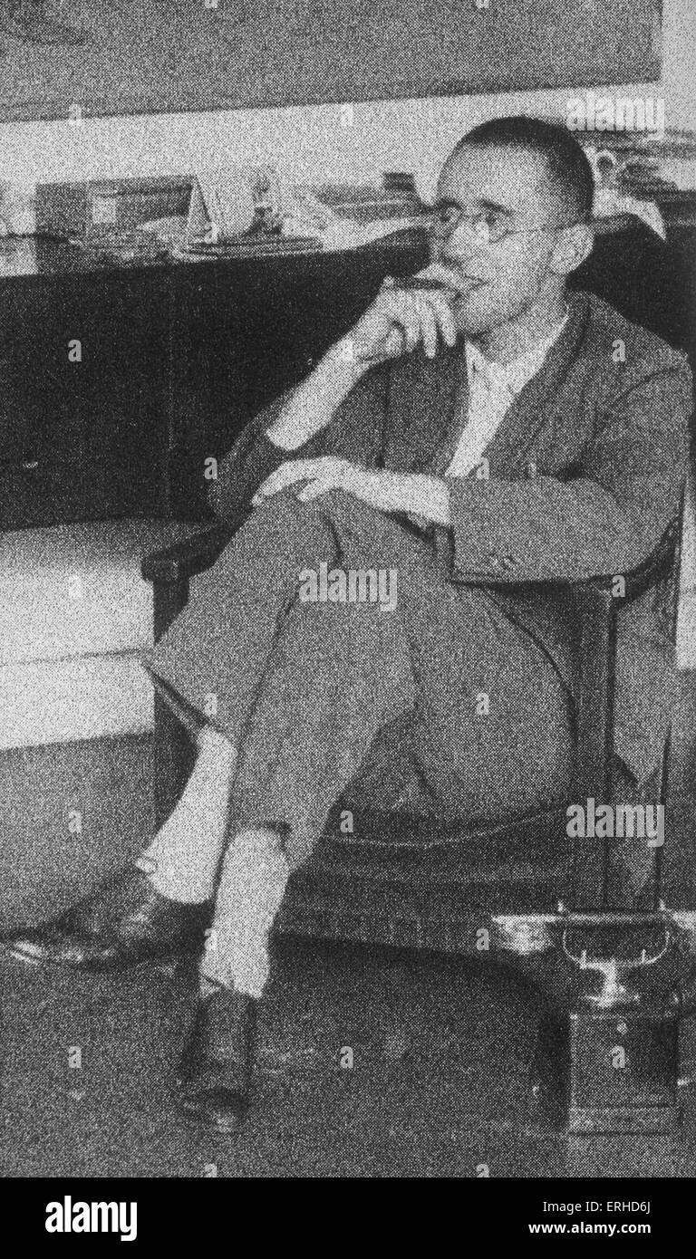 Bertold (or Bertolt) Brecht - portrait of the German poet and playwright, seated and smoking a cigar. 10 February 1898 - 14 Stock Photo