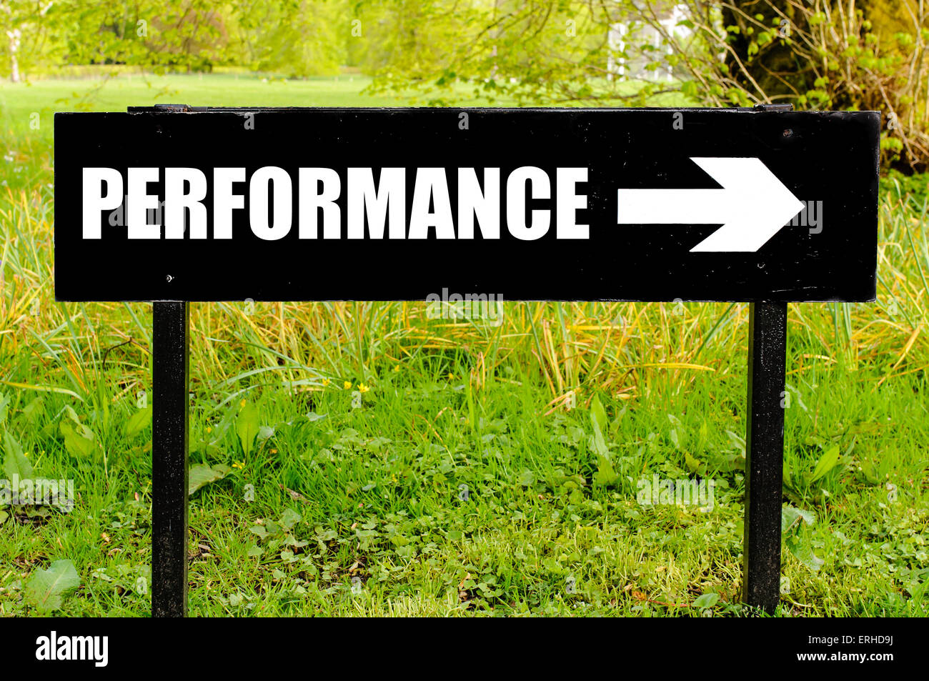 PERFORMANCE written on directional black metal sign with arrow pointing ...