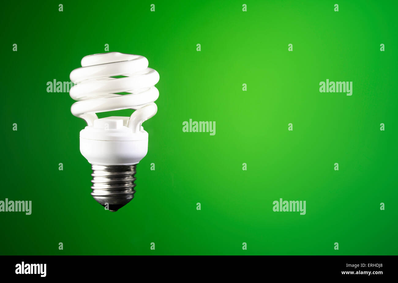 Light bulb on a green background Stock Photo