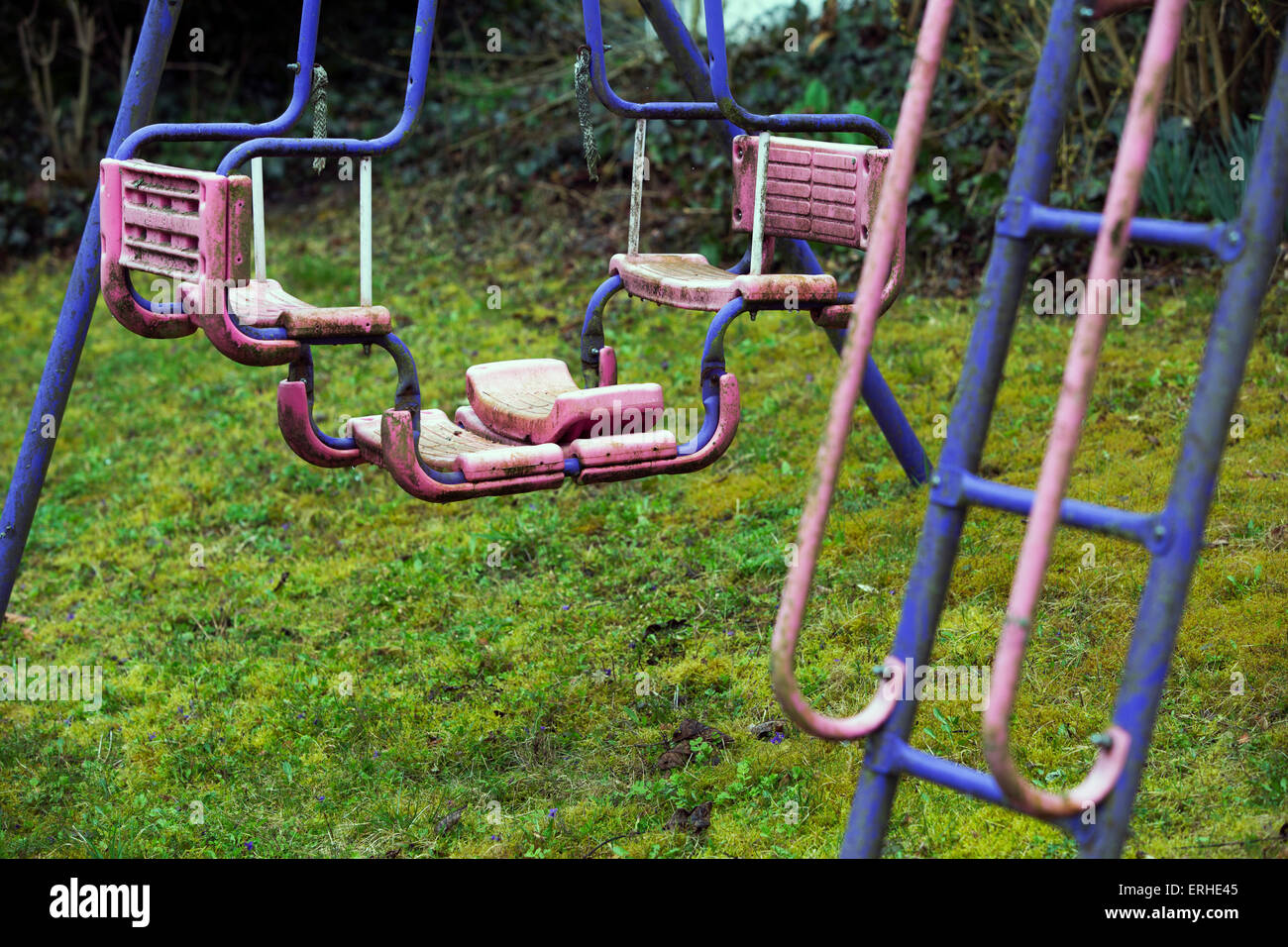 old dirty swing set on playground Stock Photo
