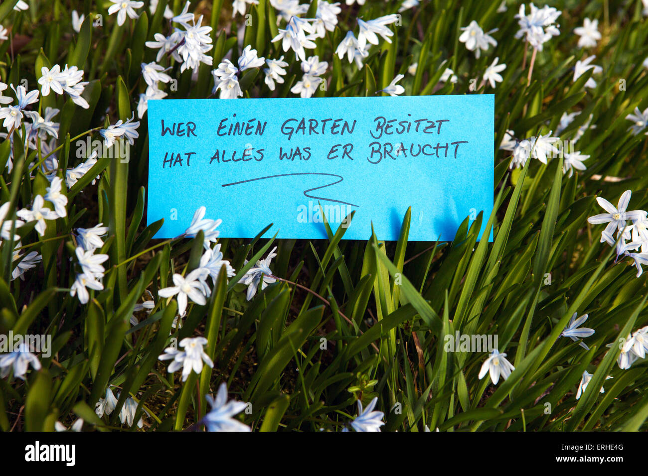 handwritten german words 'Wer einen Garten besitzt hat alles was er braucht' (those who own a garden have everything they need) Stock Photo