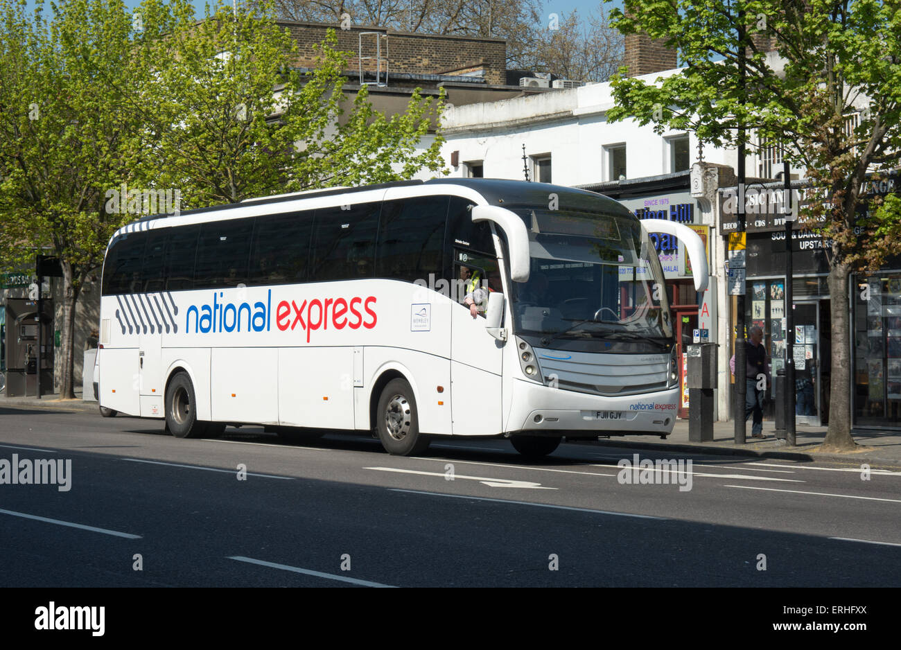 A National Express coach travels along Notting Hill gate towards its destination of London Victoria Coach station. Stock Photo
