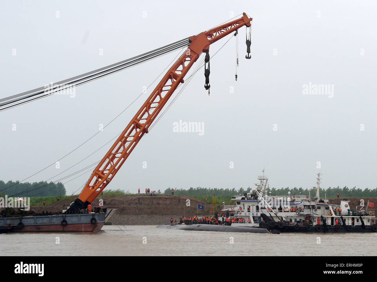 Jianli, China. 3rd June, 2015. Rescuers work at the site of the overturned ship in the Jianli section of the Yangtze River, central China's Hubei Province. As of Tuesday night, 14 people had been rescued, with seven others confirmed dead and about 430 missing in what could be the worst shipping disaster for nearly seven decades. More than 4,600 rescuers, including hundreds of divers, battled bad weather on Tuesday as they searched for the missing passengers, many of them elderly tourists. Credit:  Xinhua/Alamy Live News Stock Photo