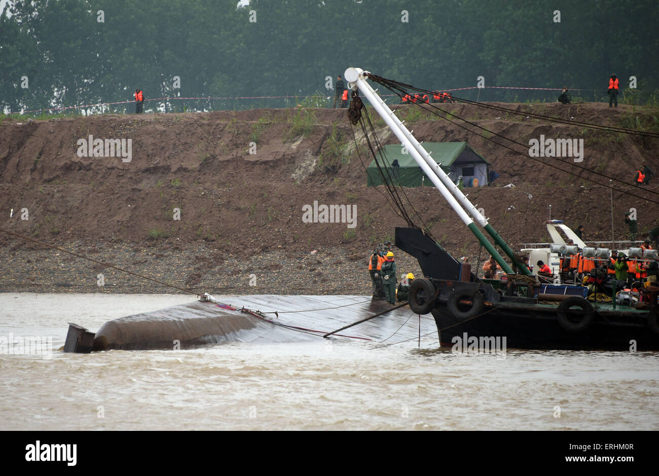 Jianli, China. 3rd June, 2015. Rescuers work at the site of the overturned ship in the Jianli section of the Yangtze River, central China's Hubei Province, June 3, 2015. As of Tuesday night, 14 people had been rescued, with seven others confirmed dead and about 430 missing in what could be the worst shipping disaster for nearly seven decades. More than 4,600 rescuers, including hundreds of divers, battled bad weather on Tuesday as they searched for the missing passengers, many of them elderly tourists. Credit:  Xinhua/Alamy Live News Stock Photo