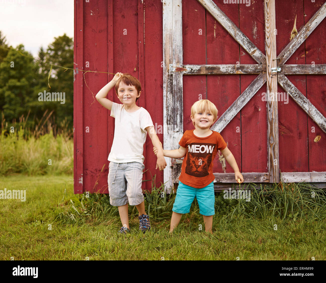 Two boys playing in a garden Stock Photo - Alamy