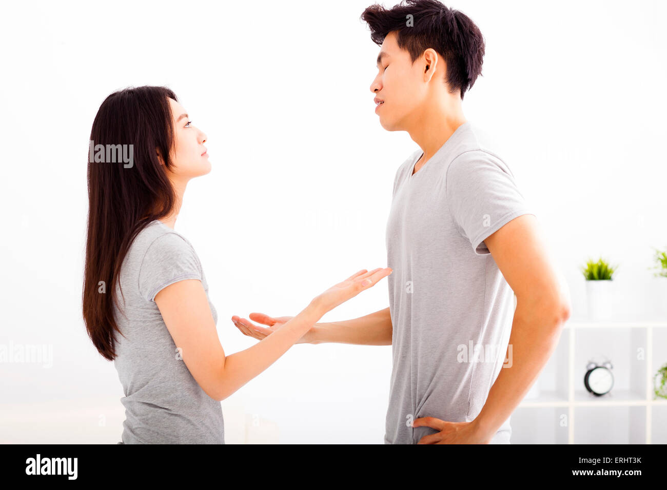 Angry young couple arguing in living room Stock Photo - Alamy