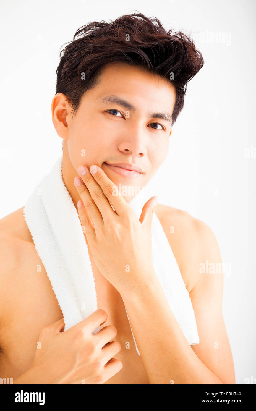 Young man touching his smooth face after shaving Stock Photo Alamy