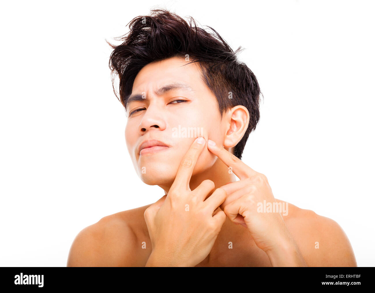 handsome young man Squeezing pimple Stock Photo