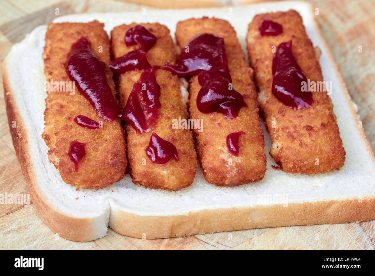 making a fish finger sandwich with ketchup Stock Photo