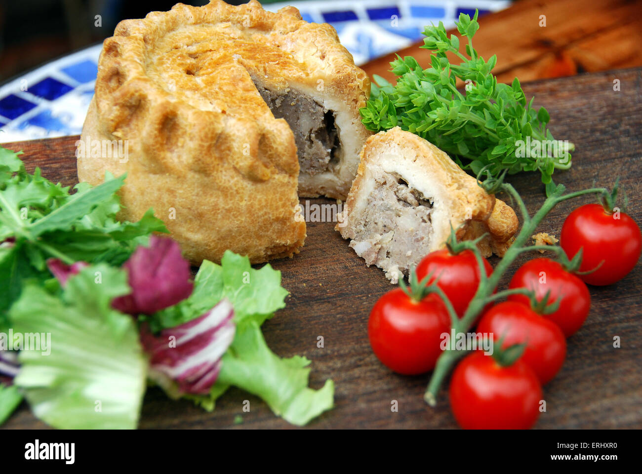 Melton Mowbray  pork pie with salad and cherry tomatoes Stock Photo