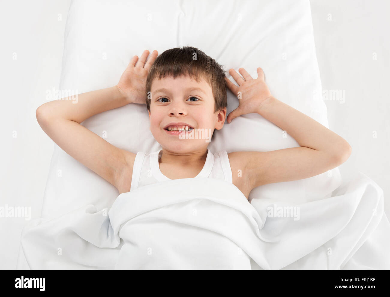 cheerful boy in white bed Stock Photo - Alamy