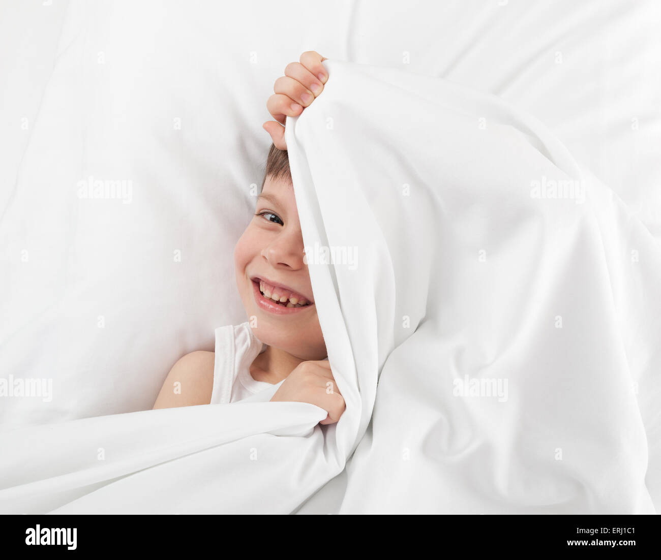 cheerful boy hiding under the blanket Stock Photo Alamy