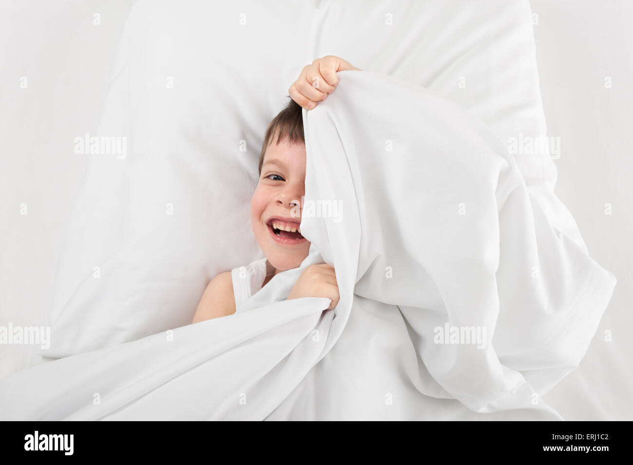 cheerful boy hiding under the blanket Stock Photo - Alamy