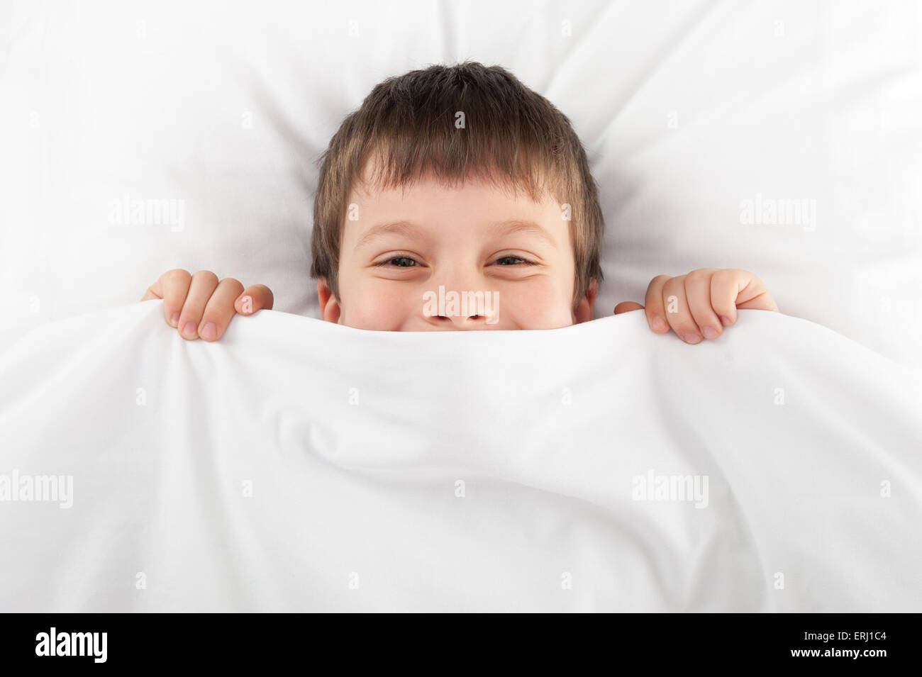 cheerful boy hiding under the blanket Stock Photo - Alamy